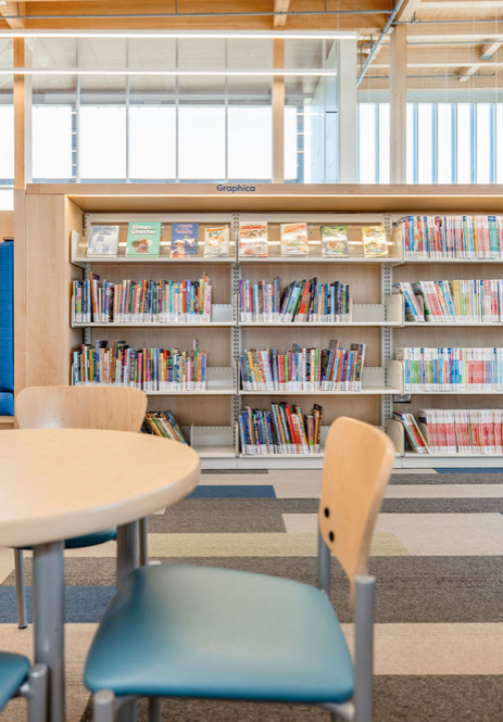 Empty white and blue metal shelving unit in an office or store, with a lockable cabinet door on the right, and a lock on the right-side panel.