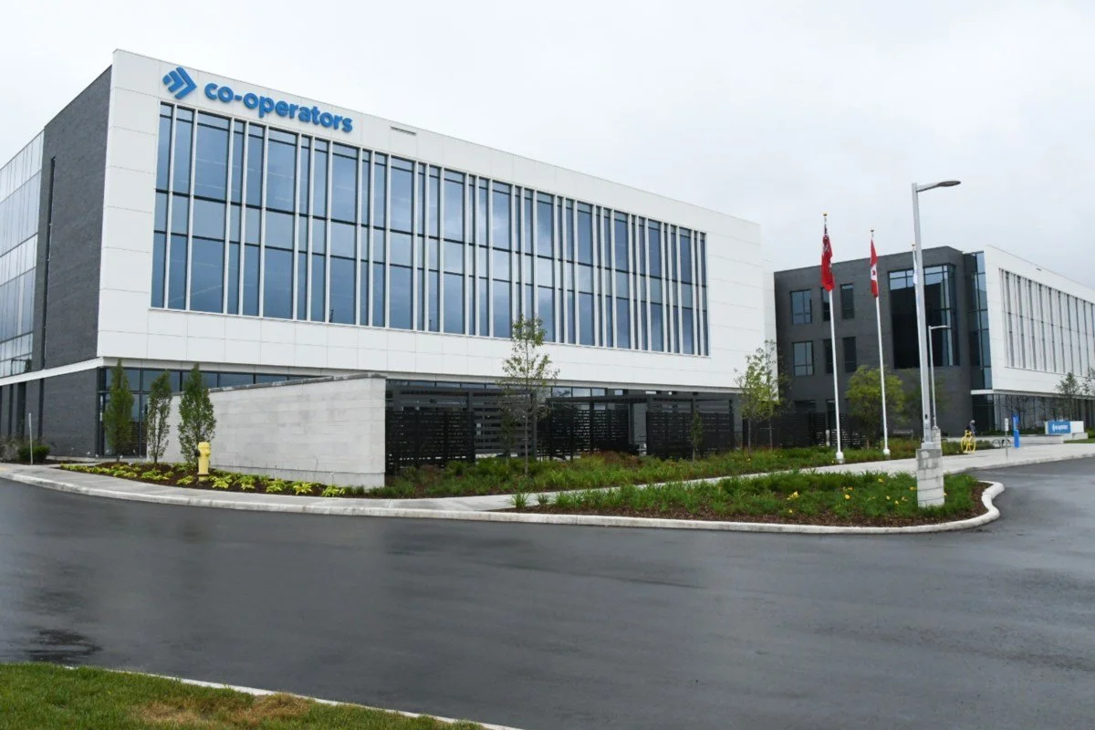Empty store shelving unit with blue sliding doors, some white shelves, and a black handle, with a small cardboard box on the bottom shelf.
