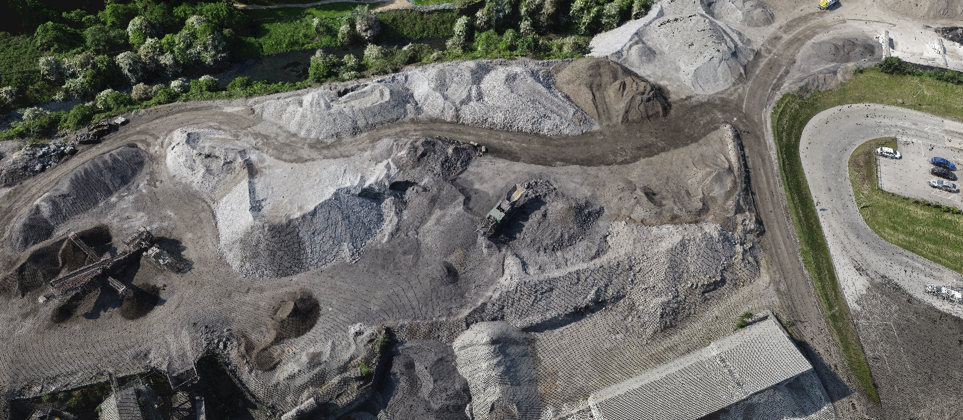Aerial drone survey view of an open-pit mine quarry used for safe volumetric analysis and stockpile measurements.