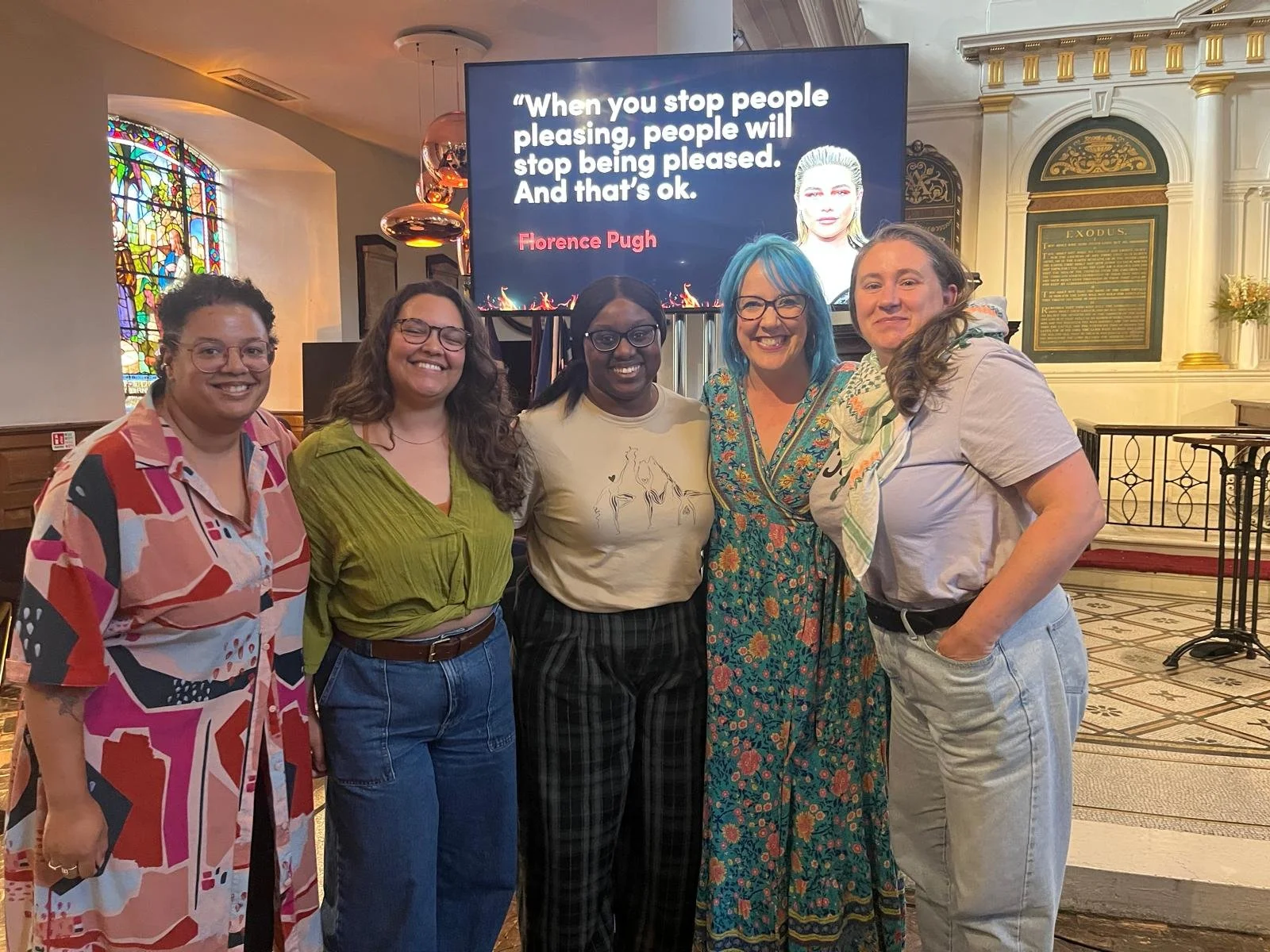 group of 5 diverse and colourfully-dresed creative women at feminist event in London