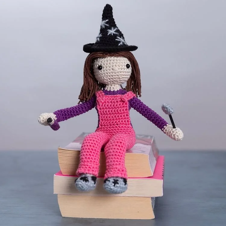 crochet word witch by mockingbirdmakes wearing pink dungarees