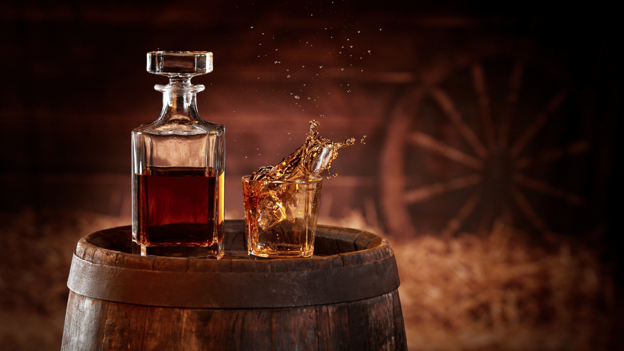 bottle of bourbon splashing glass