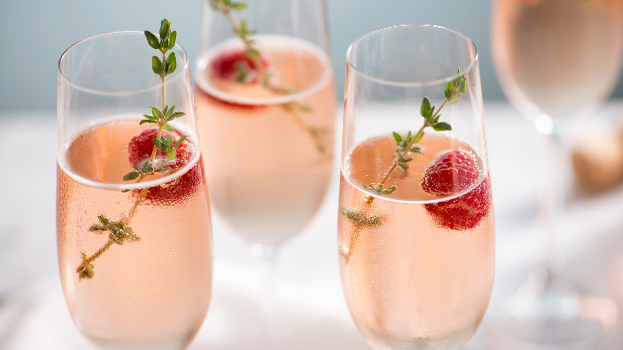 three cups with raspberry and green herb