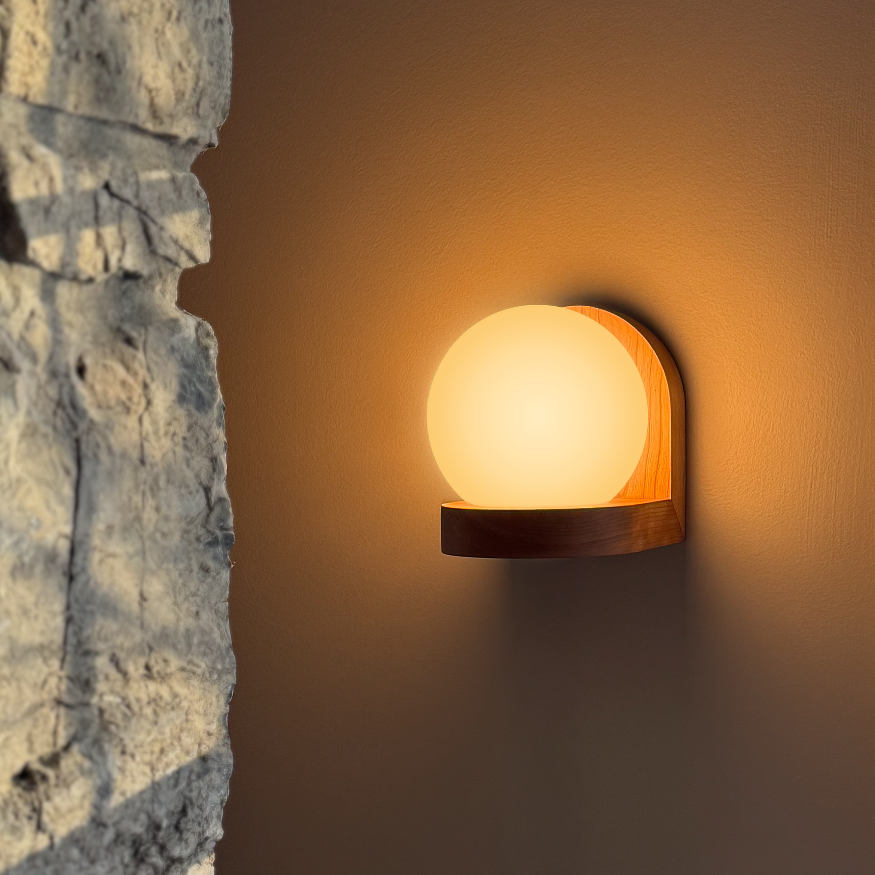 Modern, minimal wall sconce, made from solid cherry hardwood.