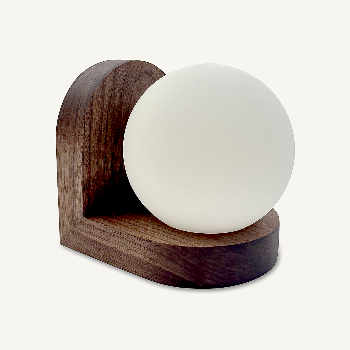 Modern, minimal wall sconce, made from solid walnut hardwood.