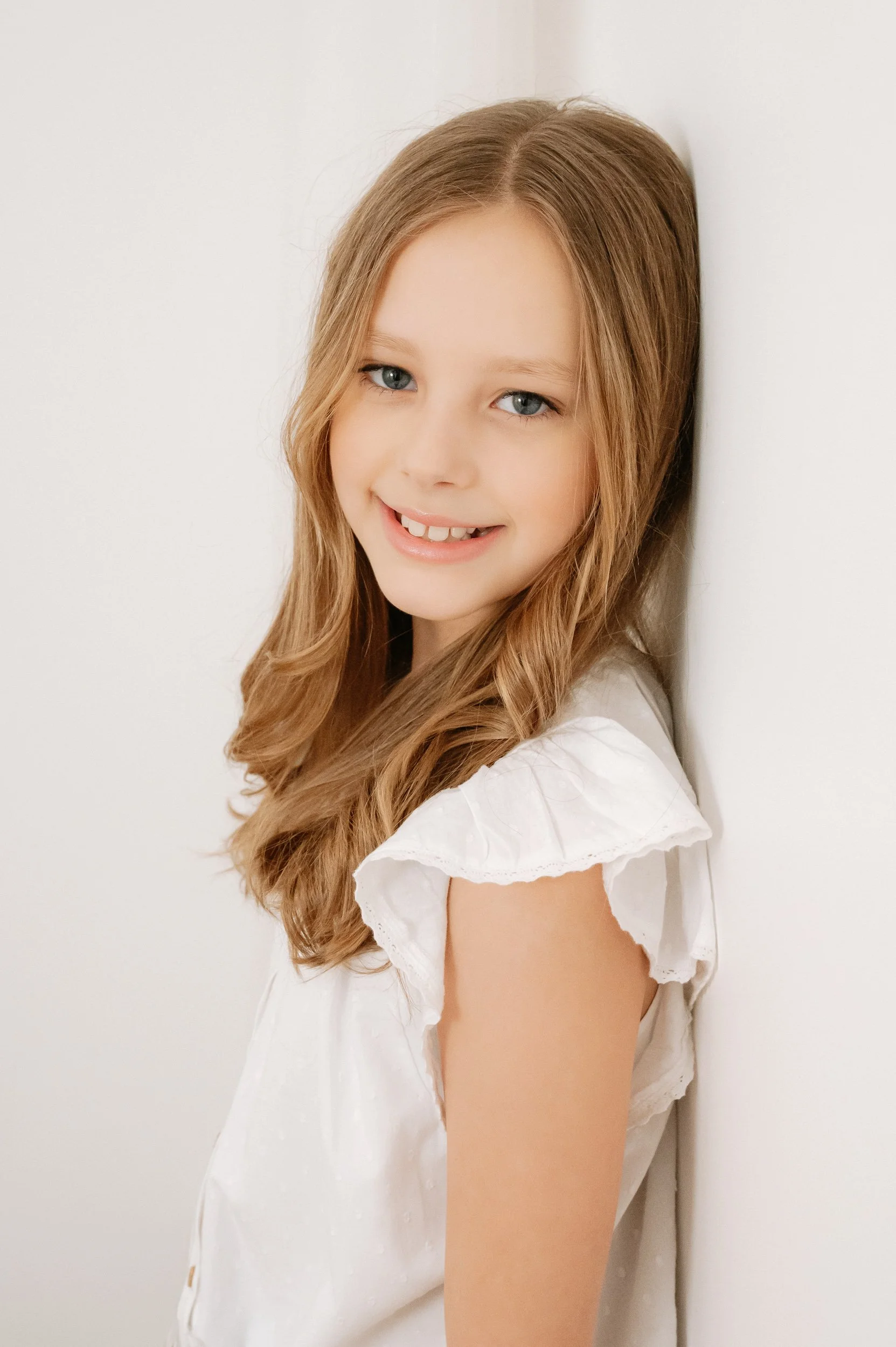 Portrait of a smiling young girl during a natural light children's photography session in Doncaster.