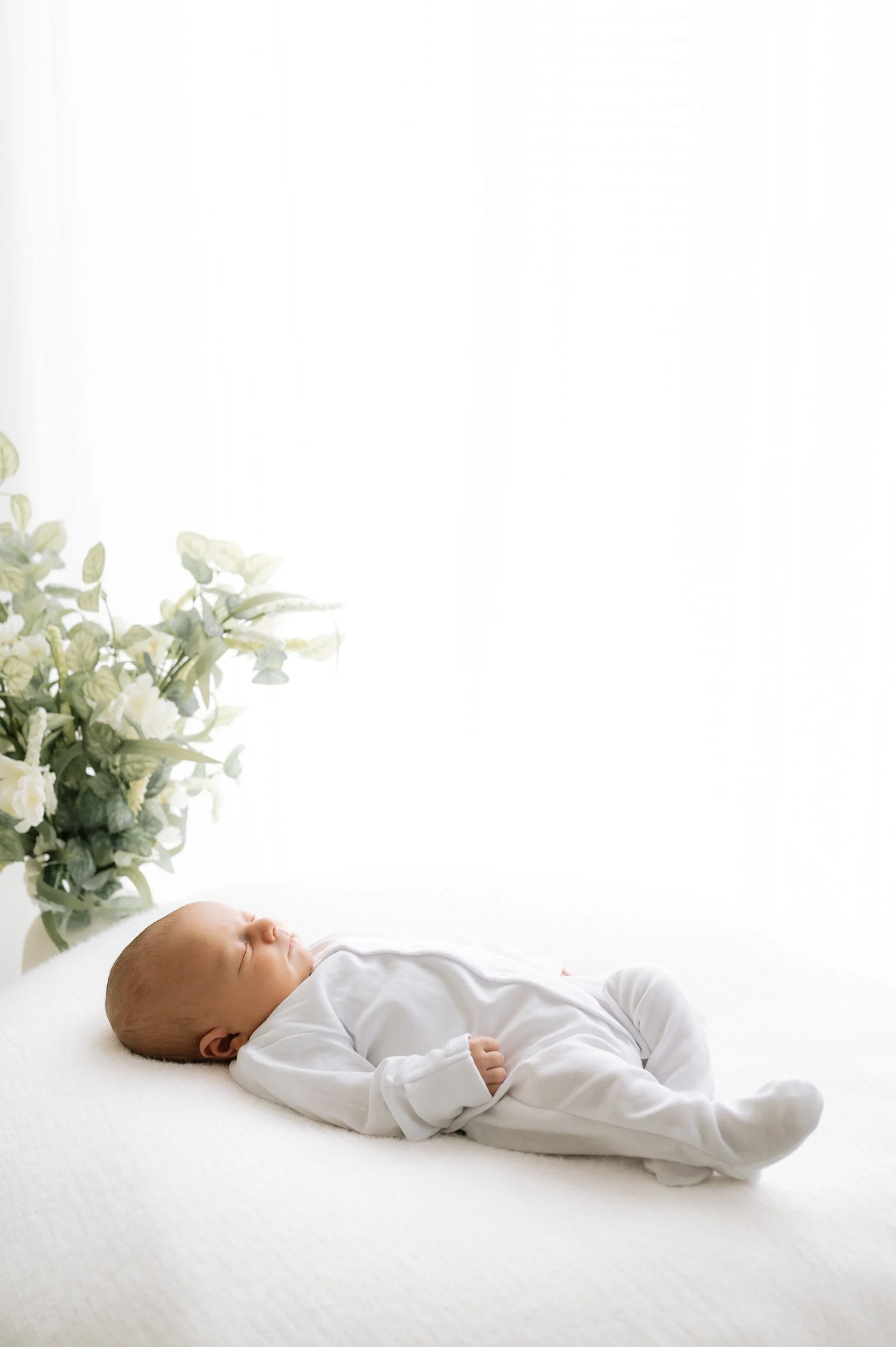 Portrait of a peacefully sleeping newborn baby during a natural light newborn photography session in Doncaster.