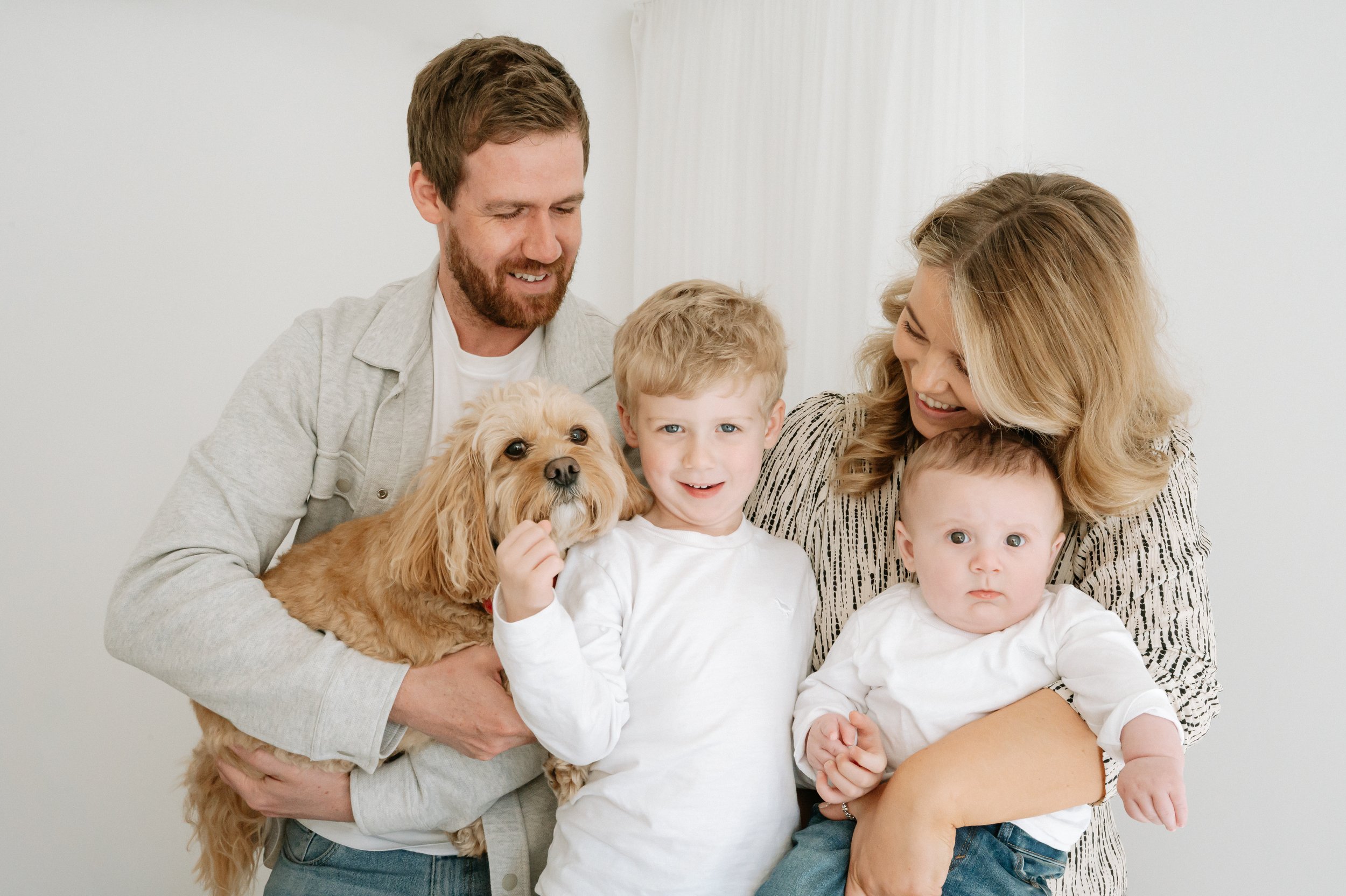 Family and their dog enjoying a natural photography session in a Doncaster studio.