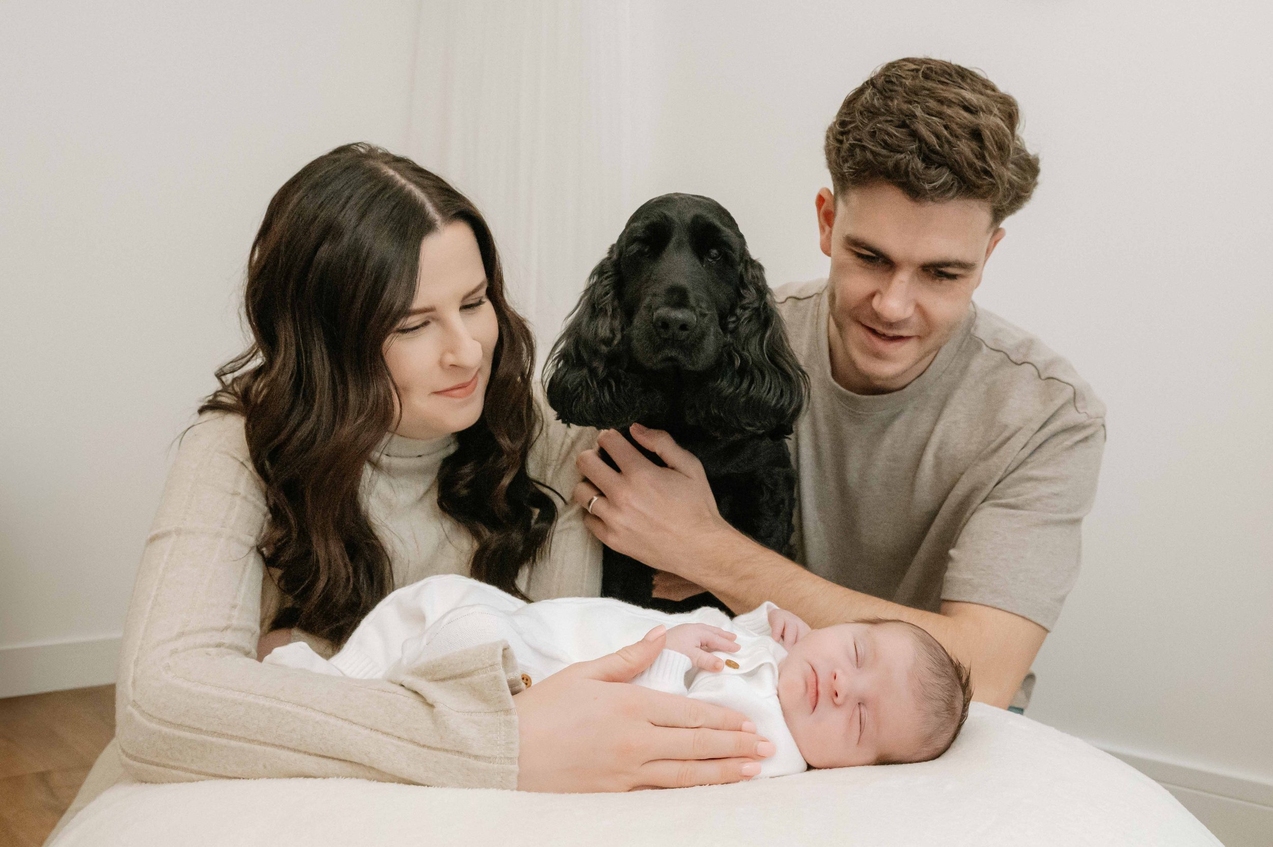 Family and their dog enjoying a natural newborn photography session in a Doncaster studio.