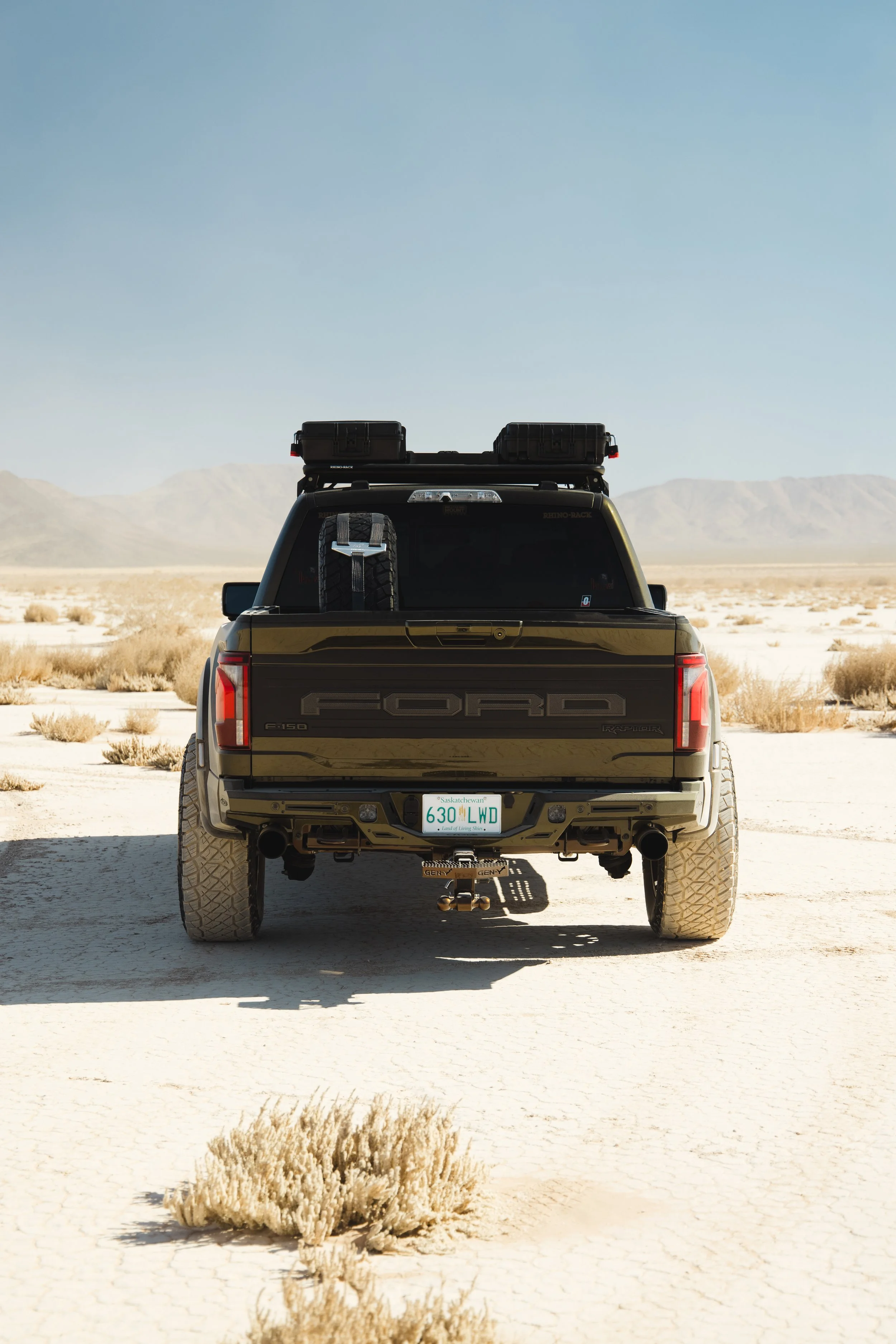 Rear shot of our Ford F-150 Raptor build, showing off the Spare tire, offroad jack, sound system, and LED Lighting in the Las Vegas Desert.