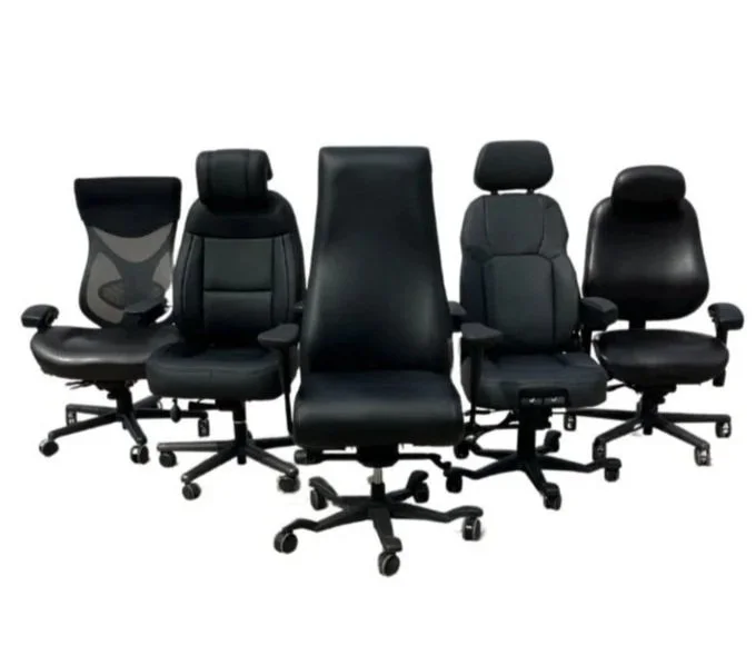 Set of five black office ergonomic chairs with adjustable armrests and wheels, positioned in a row against a plain white background.