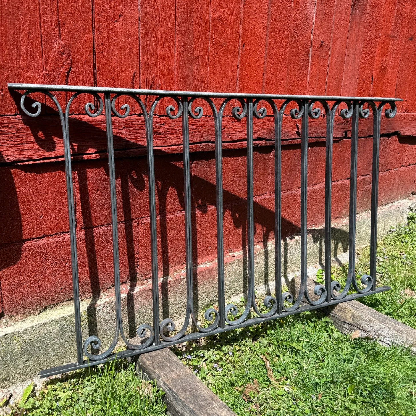Decorative steel railing panel with hand-formed scroll details