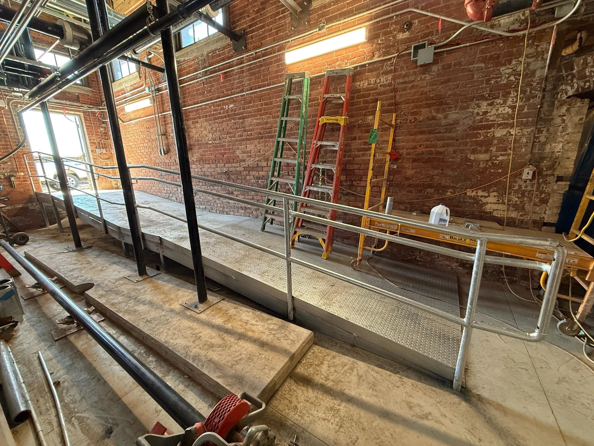 Custom commercial access ramp with steel pipe guardrails