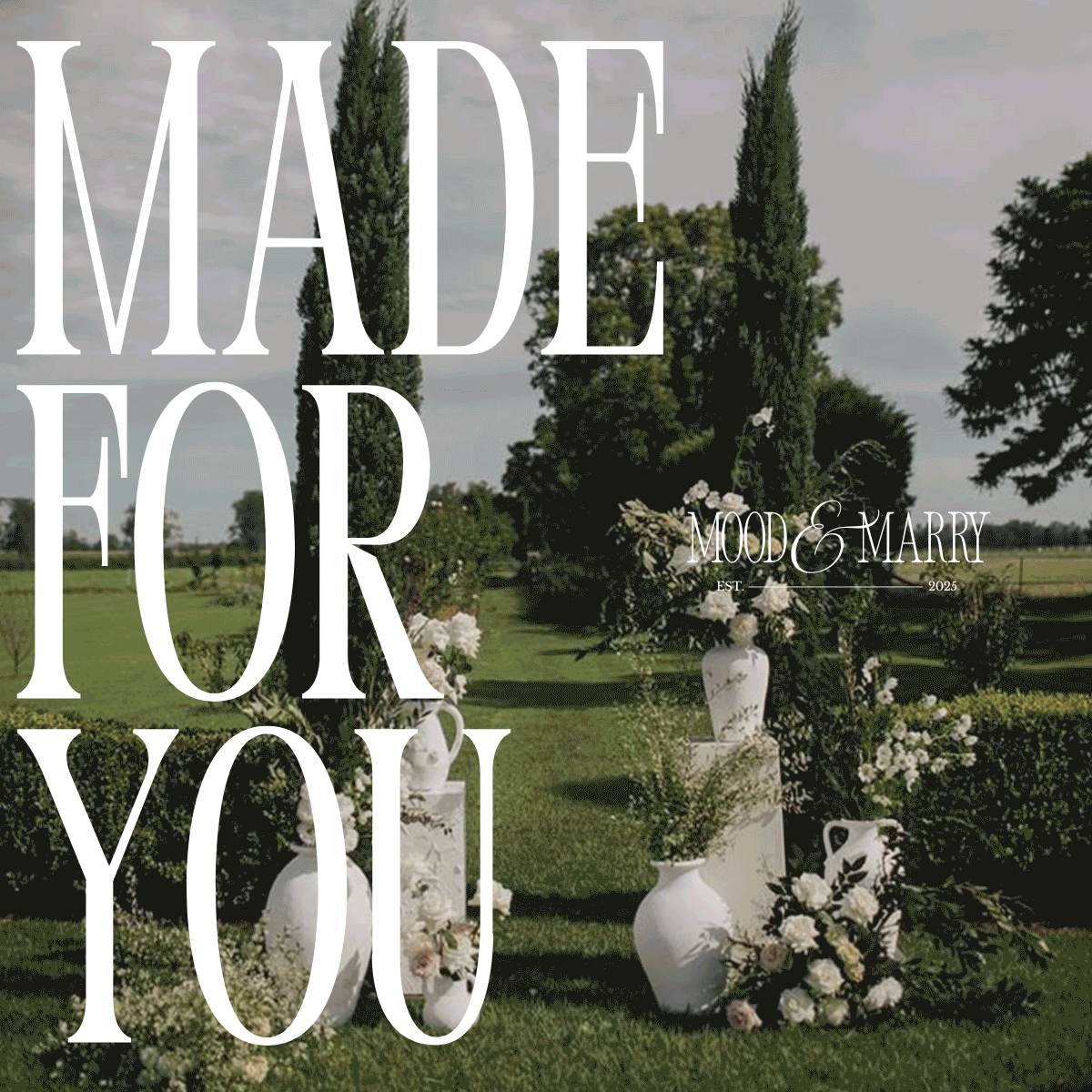 Large “Made For You” text overlaying a lush outdoor wedding setup with white ceramic vases, floral arrangements, and green cypress trees, representing personalized design service.