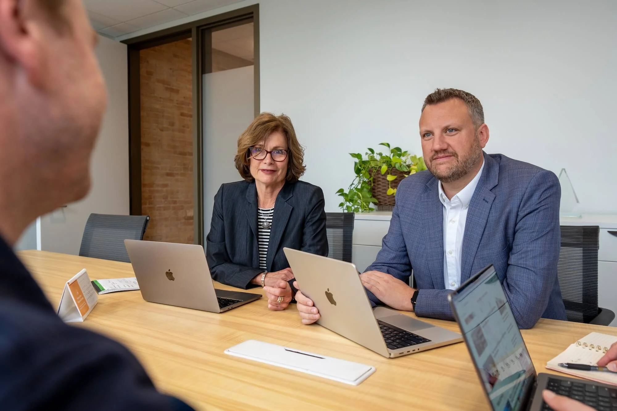Truscott Rossman Executive Consulting advisory team sits in a meeting with a client.