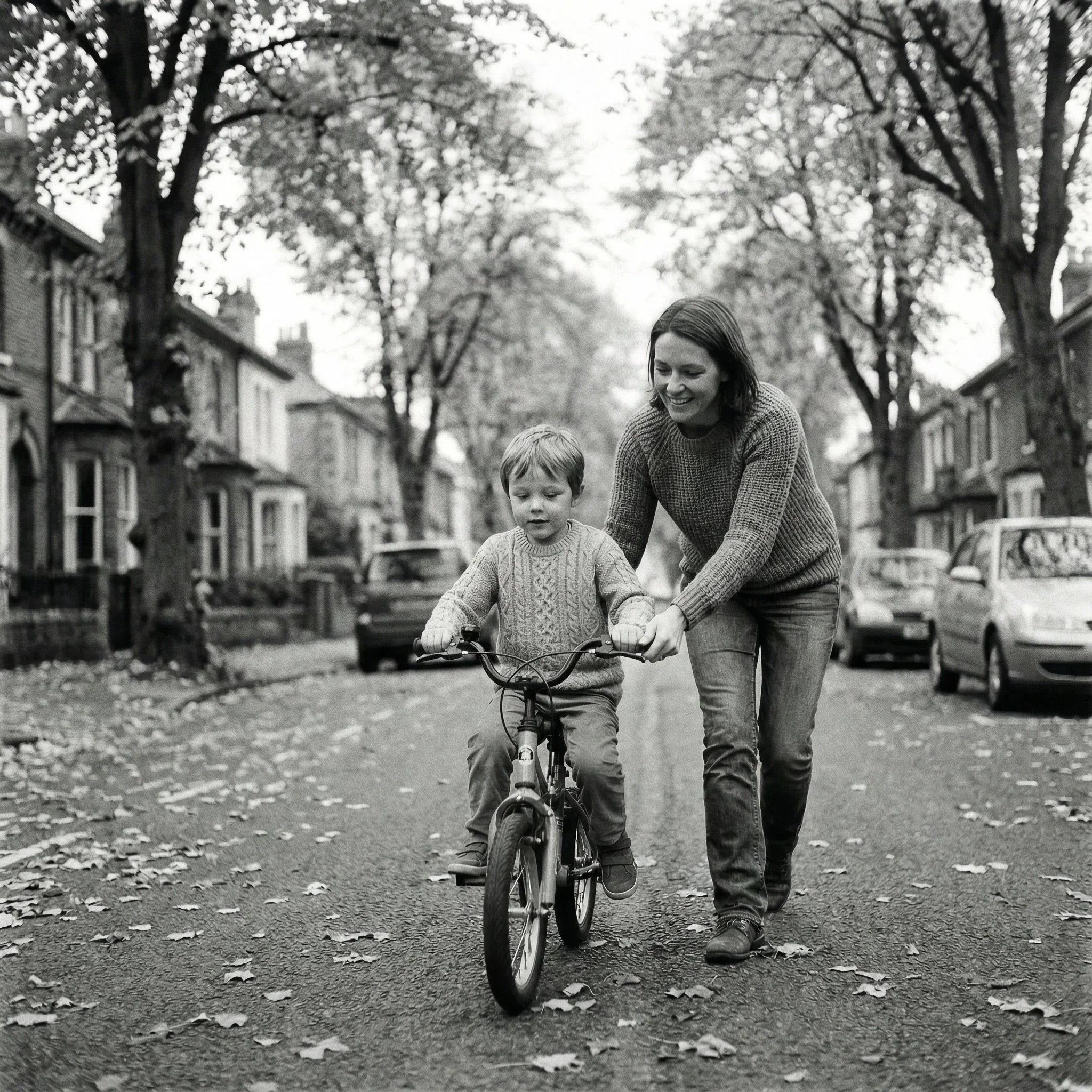 Child learning to ride a bicycle with help from an adult, representing guided learning and skill development.