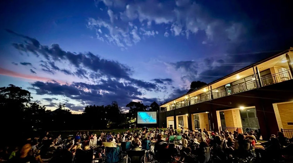 People attending an outdoor evening event