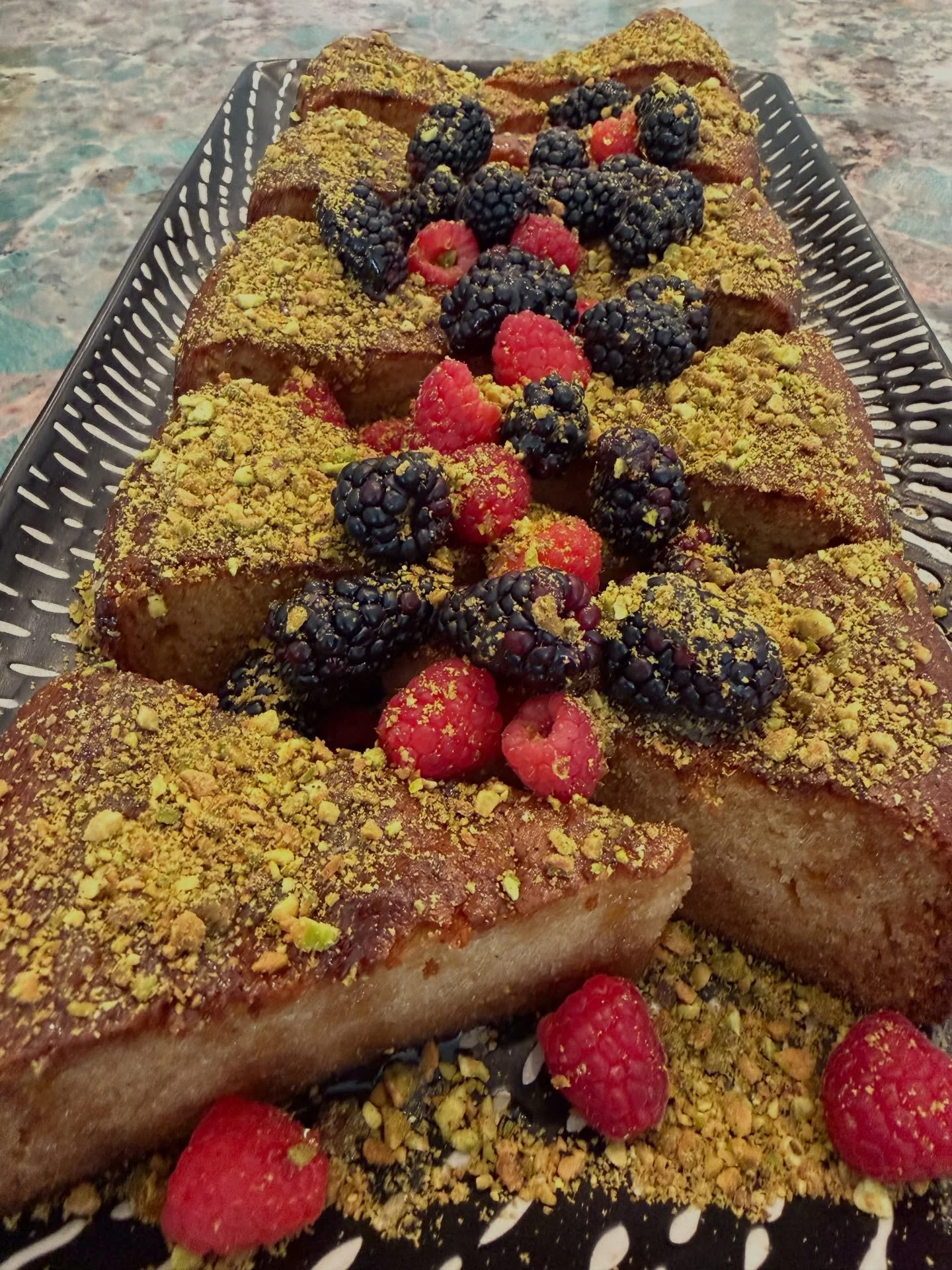 Vanilla Orange Olive Oil Cake with Pistachio, Yogurt whip on the side, local honey, and seasonal berries.