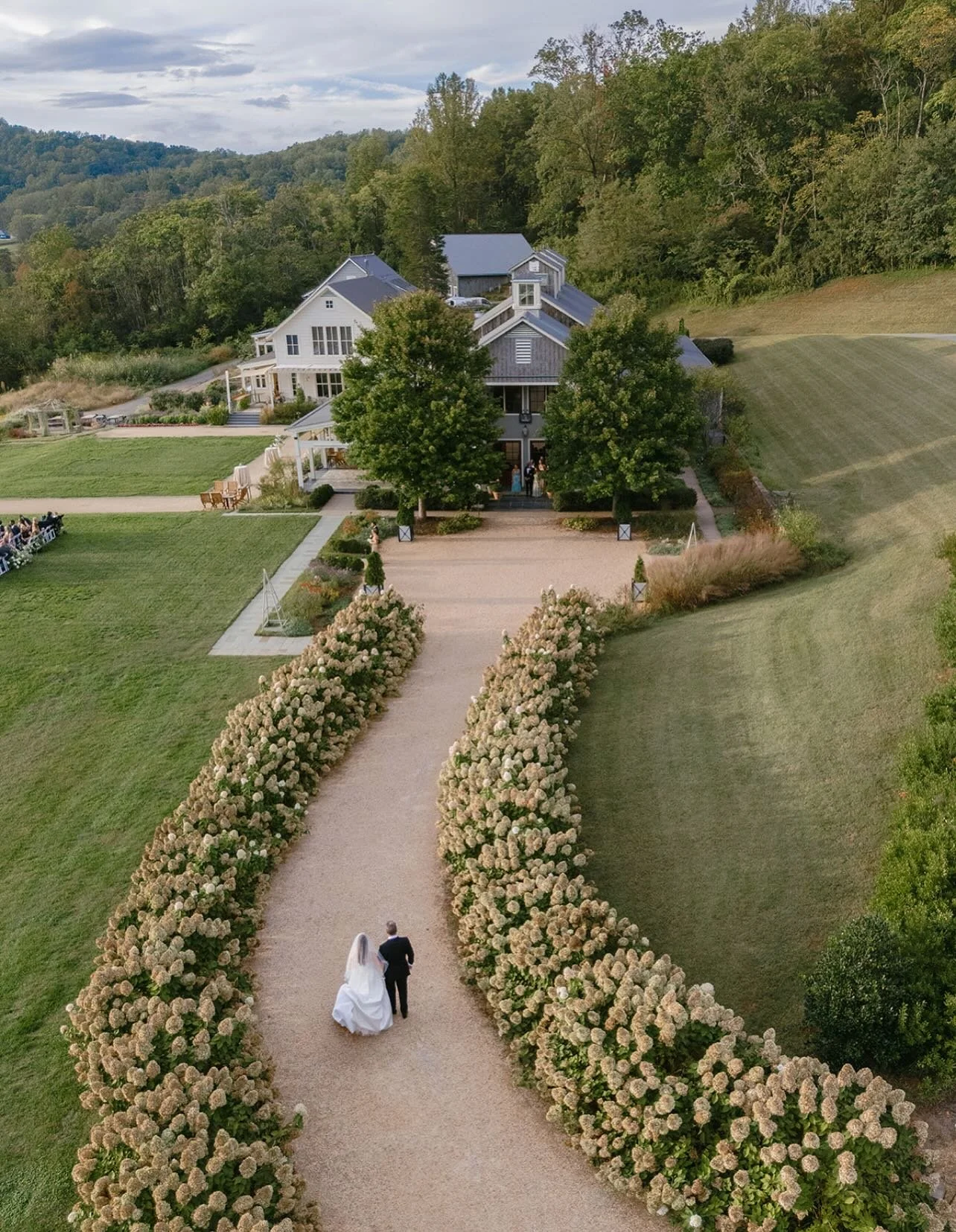 Golden hour on the horizon, hydrangeas, and the sweetest walk to &ldquo;I do.&rdquo; ✨🌸 

@hanagonzalezphoto 
@lalmoyadesign 
@pippinhillfarm 
@makeupbyalby 
@bbjlatavola 
@kenzwilli @zgrims 

🎬Behind the scenes content under McKenzie + Zach in our