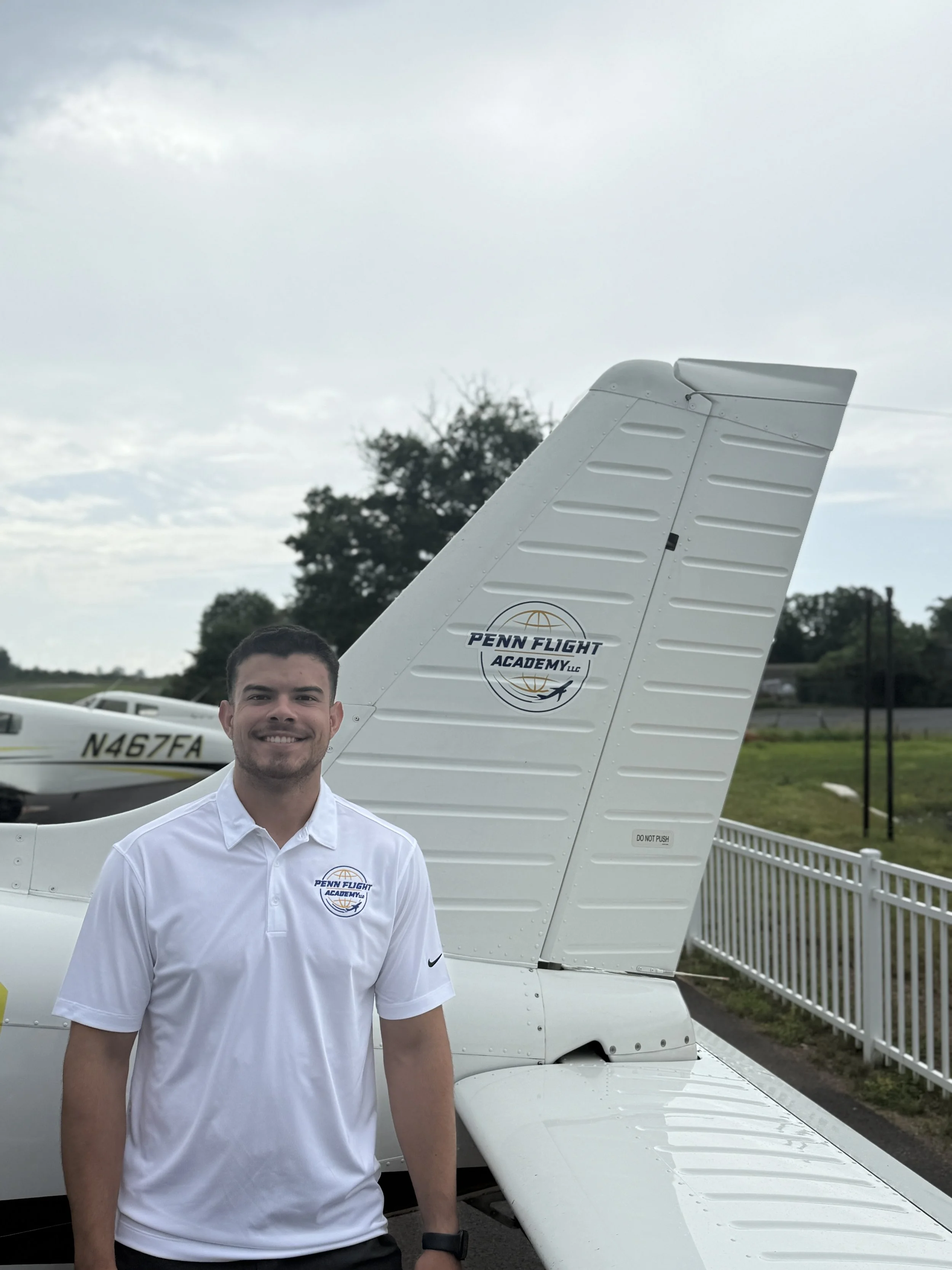 Logo of Penn Flight Academy LLC with a globe design and airplane icon.