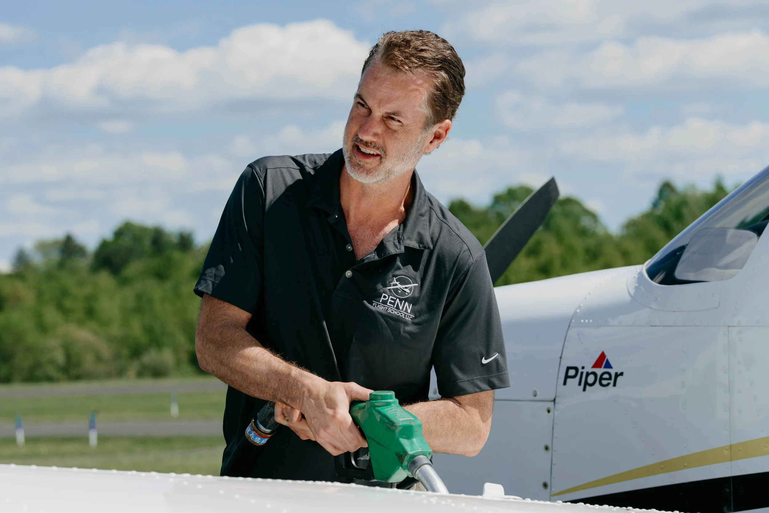 Penn Flight Academy LLC logo featuring a globe with an airplane icon.