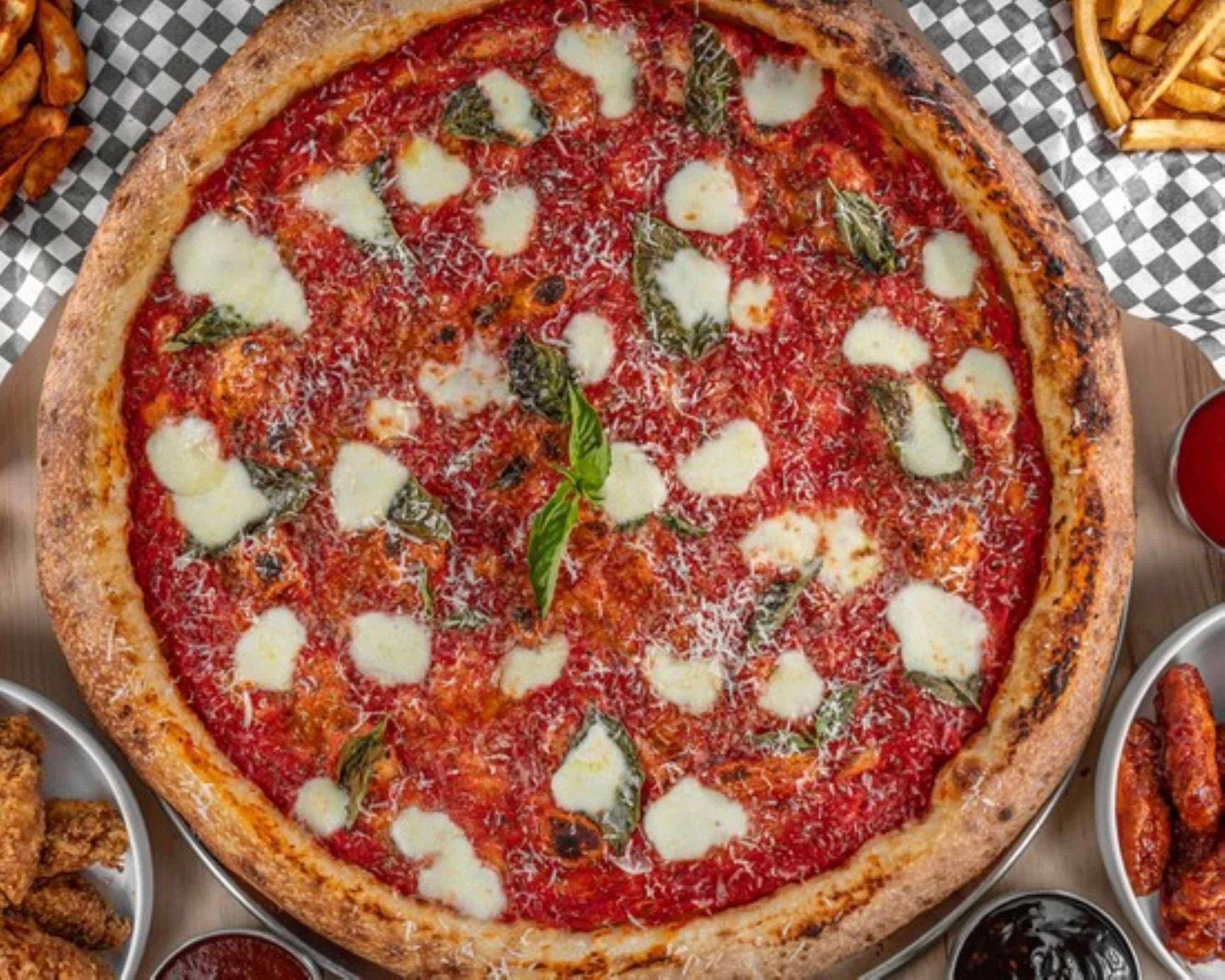 Freshly baked sourdough pepperoni pizza served on a tray at Acute Pizzeria on Dundas Street West in Toronto