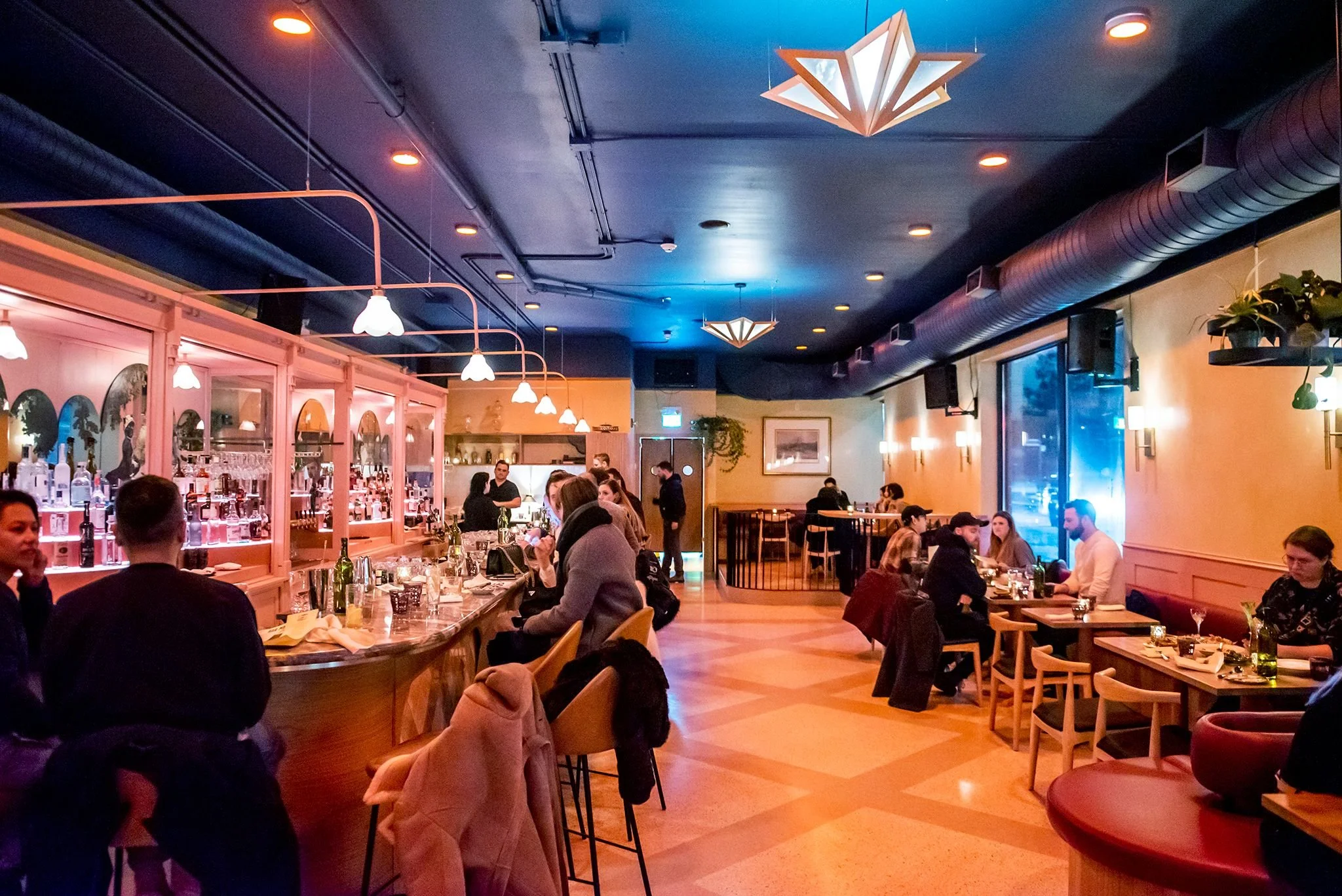 Eclectic interior seating and retro bar decor inside Bar Mordecai on Dundas Street West in Toronto