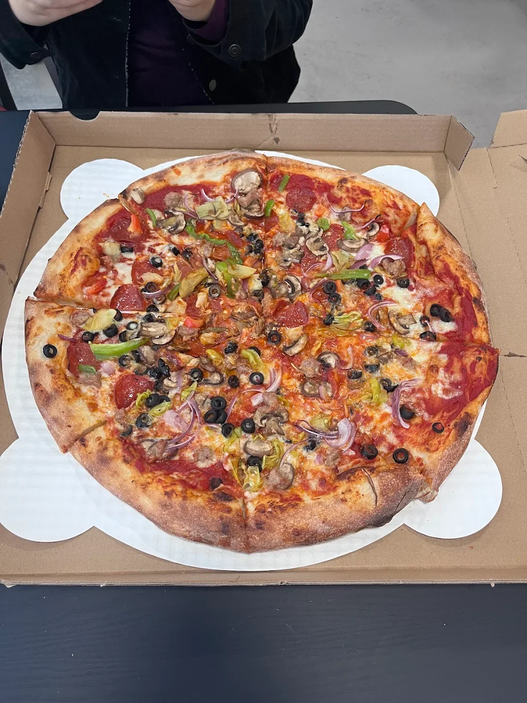 An 8Moose speciality 20 inch whole pie with an assortment of toppings including black olives, mushrooms, red onions, green peppers, pepperoni, and sausage. 
