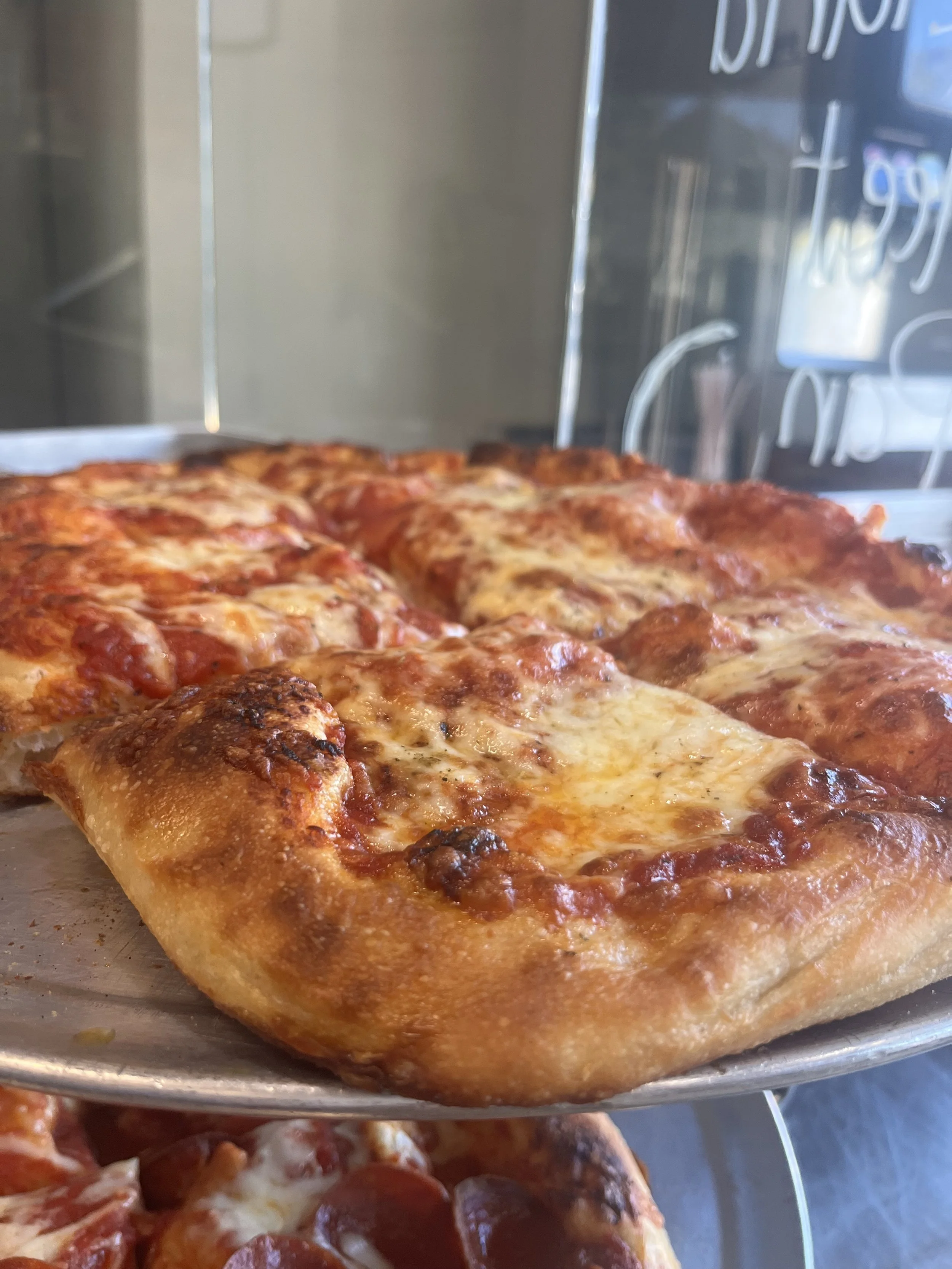 Close-up of a Cleveland Sheet style cheese pizza, ready to be served. 