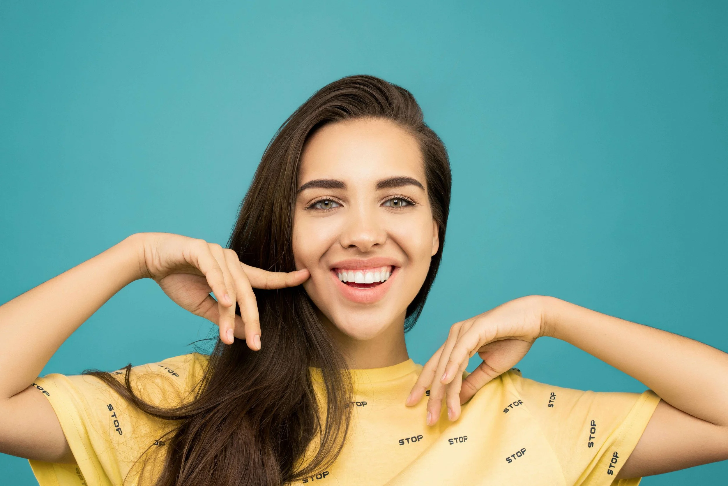 A woman smiling with her hands on her cheeks. Are you wondering whether or not you’re a people-pleaser? Explore the signs and therapeutic solutions for breaking unhealthy habits through relationship therapy in Davie, FL.