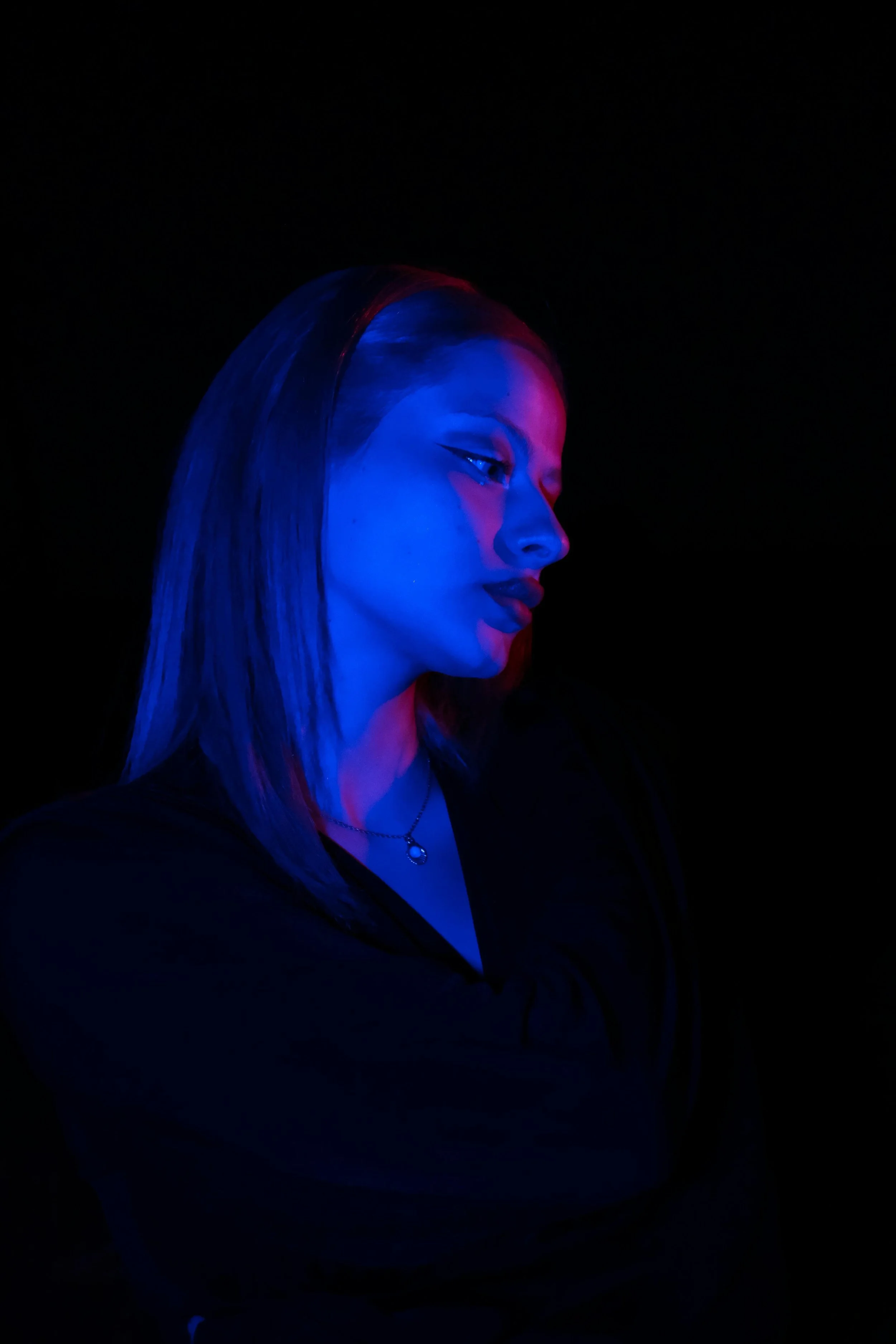 A woman's profile is illuminated by blue neon light. When you ignore your own needs, does resentment build in relationships? Relationship therapy in Davie, FL, teaches how to establish boundaries that honor your emotional well-being.