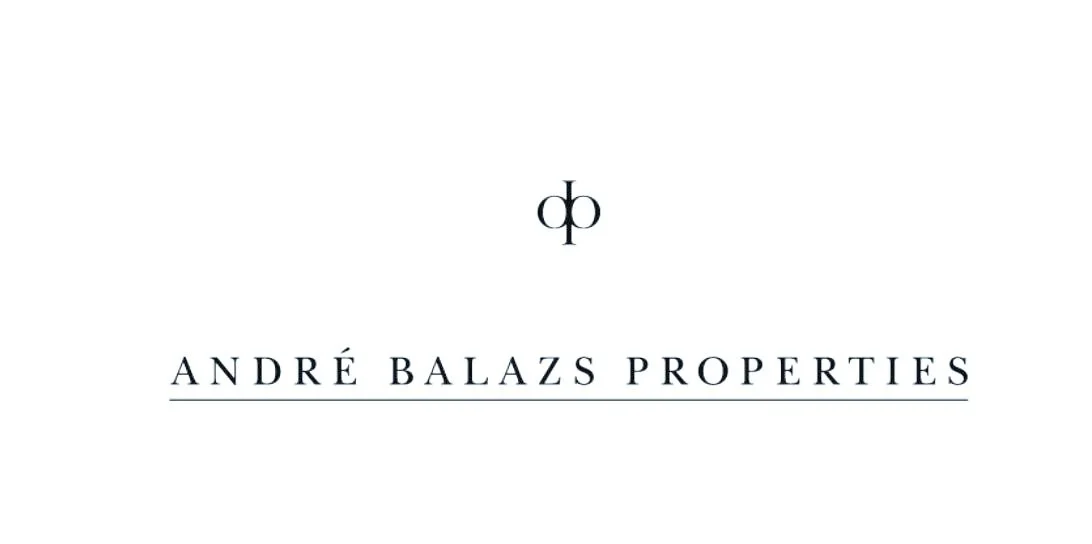 A minimalist album cover with a white background, featuring a black logo at the top, followed by the text 'ANDRÉ BALAZS PROPERTIES' in uppercase letters and a thin underline.