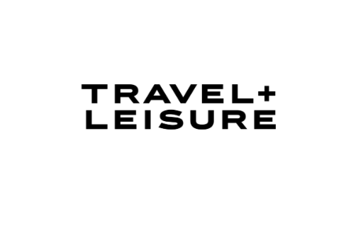 Black text reading "Travel + Leisure" on a white background.