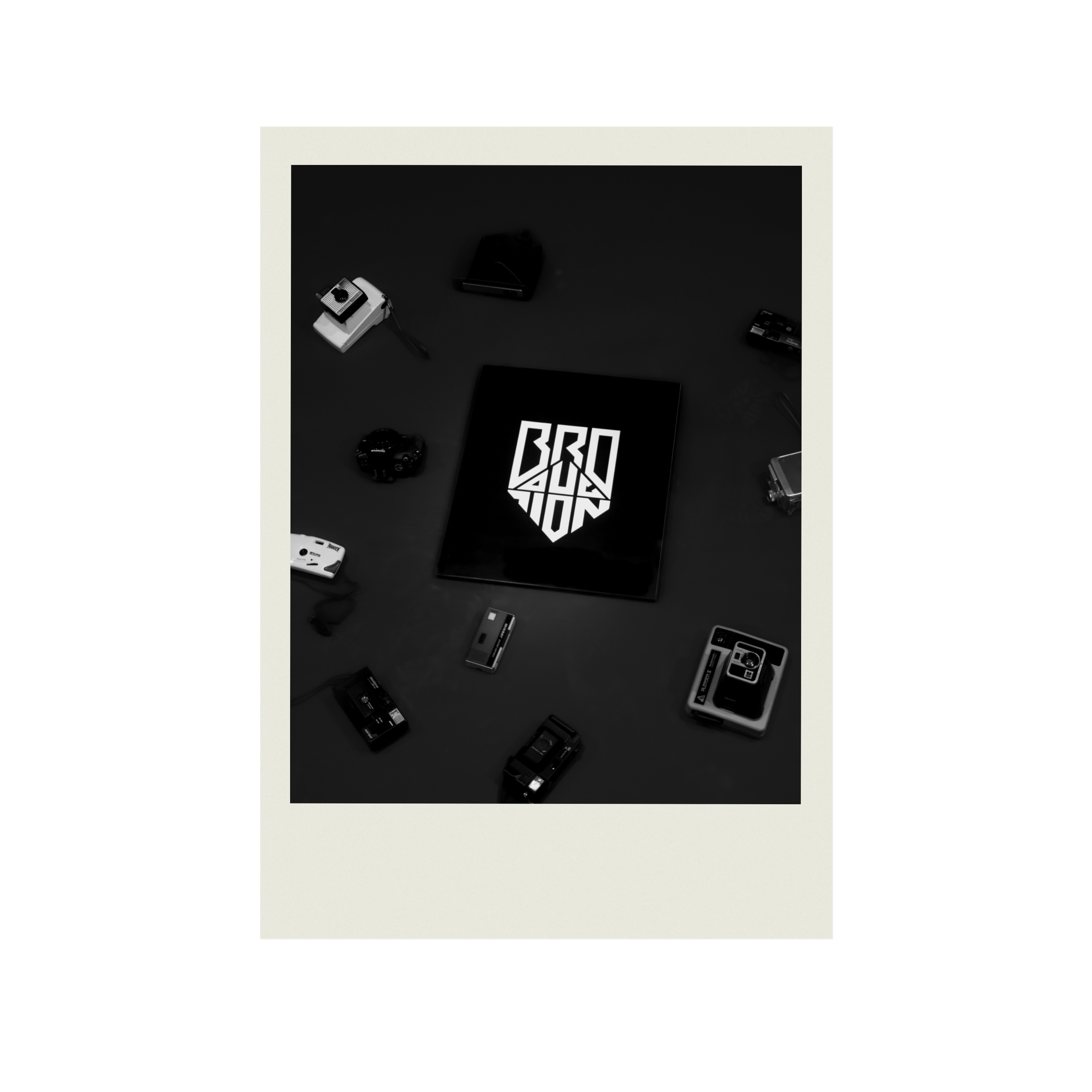 Black and white photo of various electronic gadgets and items on a dark surface.