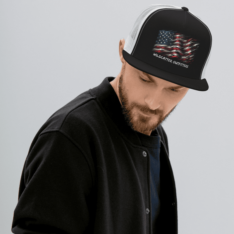 Man wearing a black and white baseball cap with an American flag design and the words "Wildcatter Outfitters."