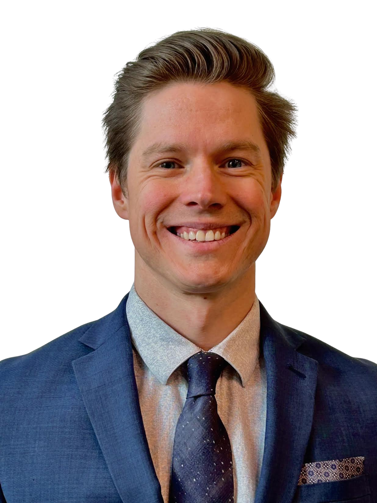 Portrait of a young man with brown hair, wearing a blue suit, patterned tie, and light-colored shirt, smiling.