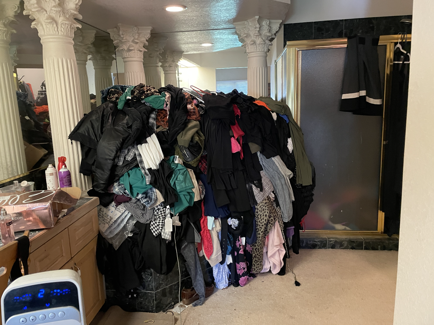 large pile of clothes in bathtub