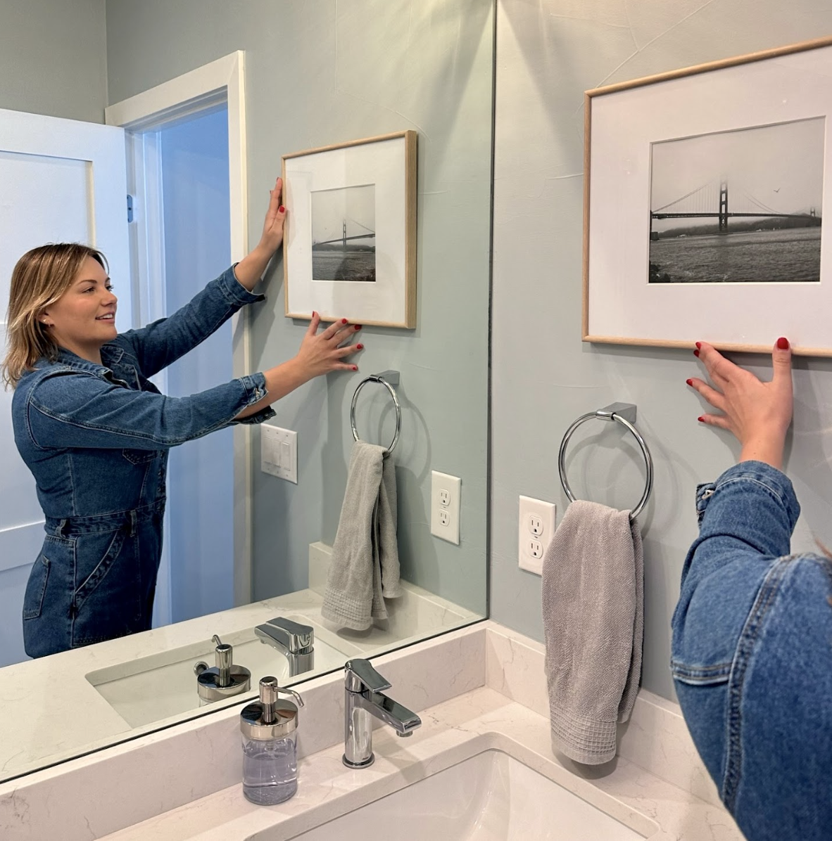 Owner + Organizer Carina adjusting a picture frame