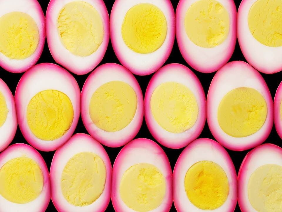 Cut in Half by Food Stylist Charlotte Omnes & Photographer Beth Galton-Halved pickled eggs with pink whites and yellow yolks
