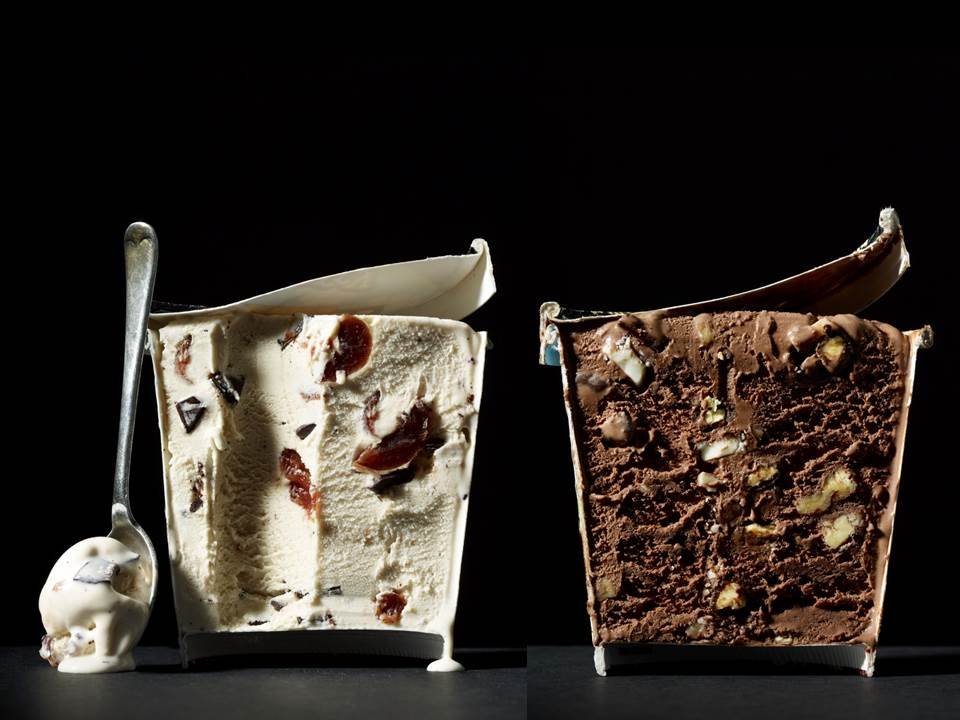 Cut in Half by Food Stylist Charlotte Omnes & Photographer Beth Galton-Two partially sliced containers of ice cream, showing the contents inside. One is vanilla with chocolate and fruit pieces, the other is chocolate with nuts.