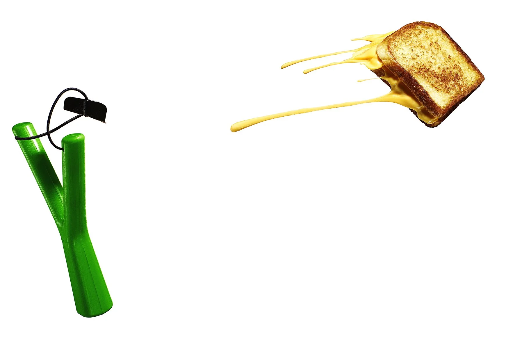 Green slingshot launching a grilled cheese sandwich with cheese dripping, on a white background.