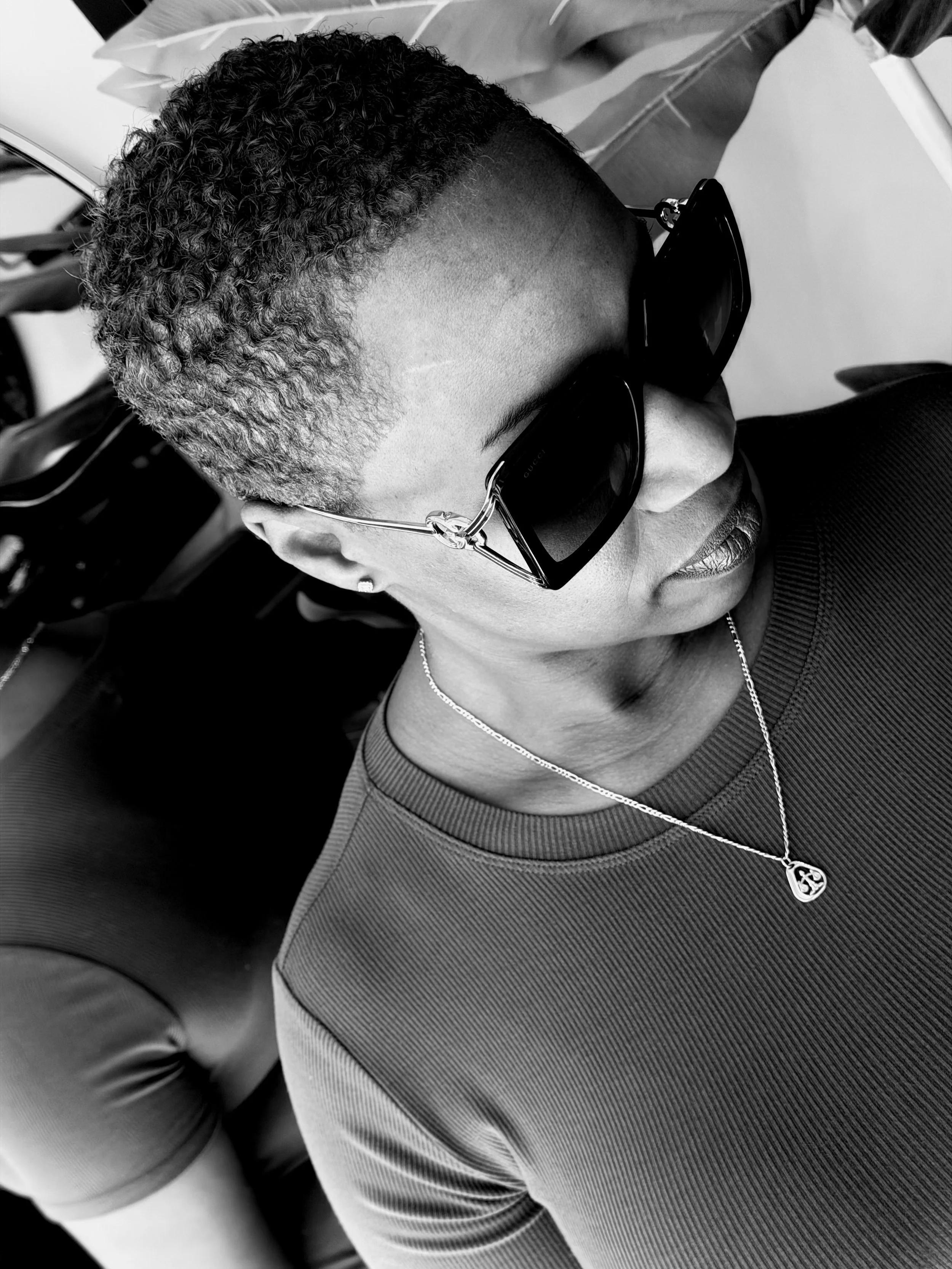 Black and white image showing precision short natural haircut with defined texture and clean shaping.