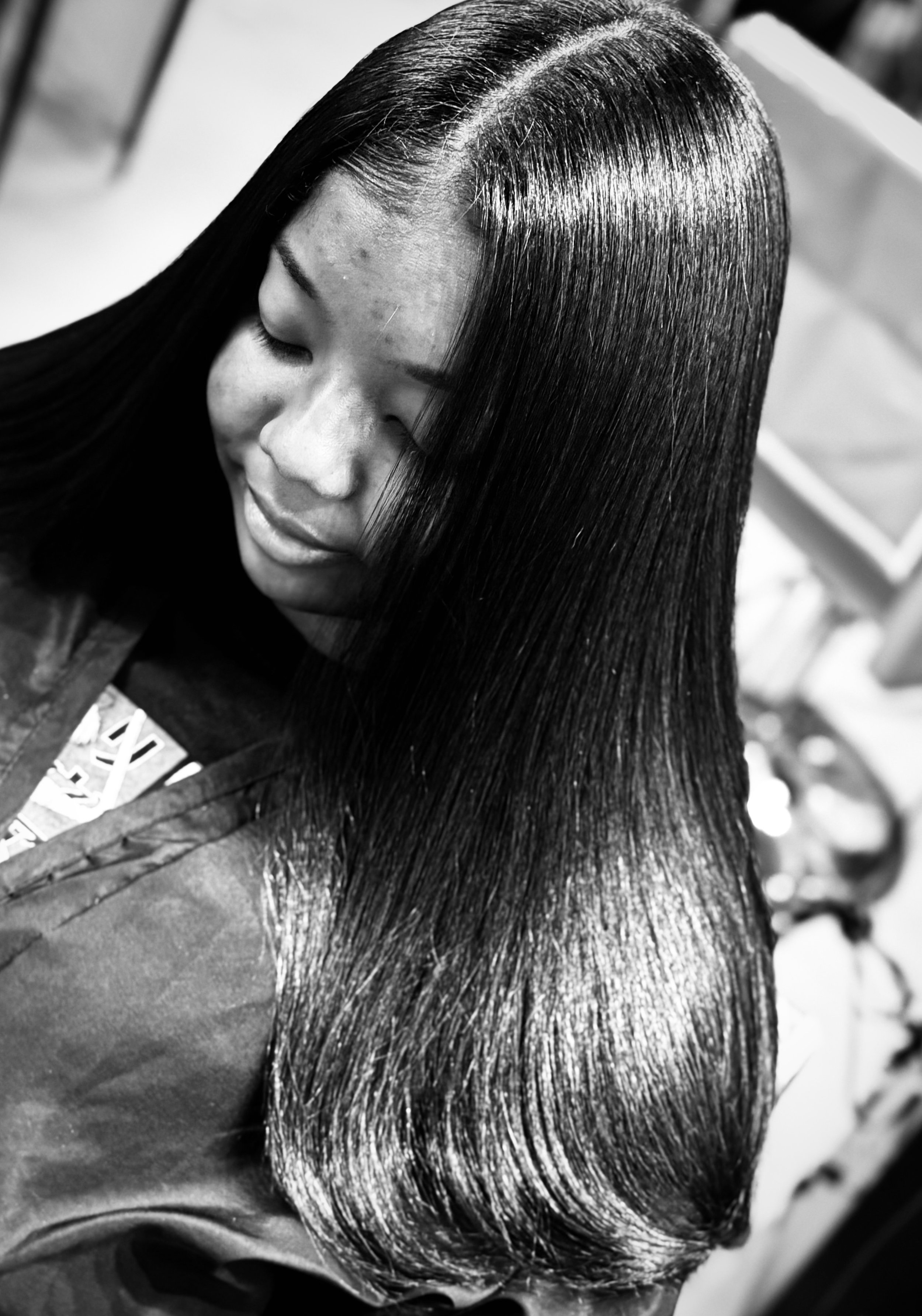 Luxury silk press keratin treatment showing healthy, sleek hair with exceptional shine and smooth movement.