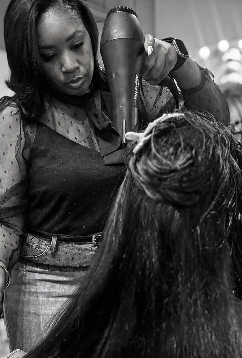 Luxury healthy hairstylist blow drying  hair extensions at Just Glo in Chicago