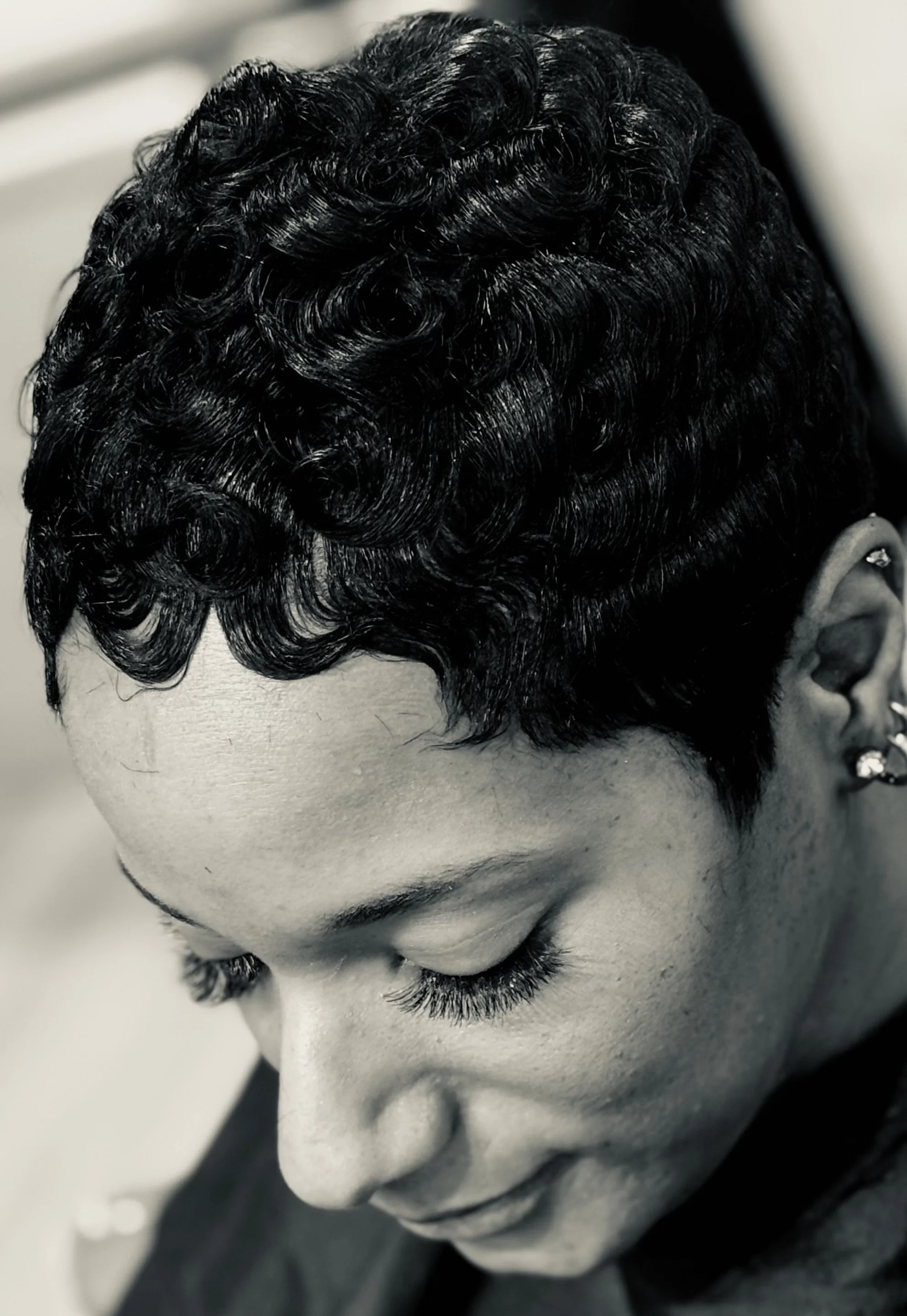 Luxury short hairstyle showcasing sculpted curls, healthy hair, and precision styling.