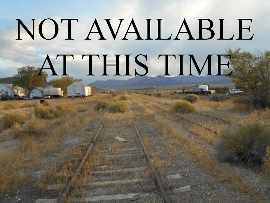 Mountain landscape at sunset with a silhouetted mountain against an orange sky.