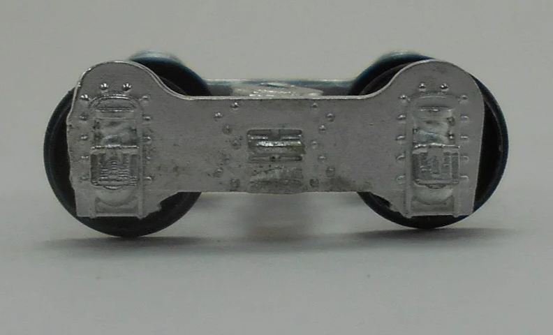 Close-up of a model train wheel assembly showing metal wheels and undercarriage details.