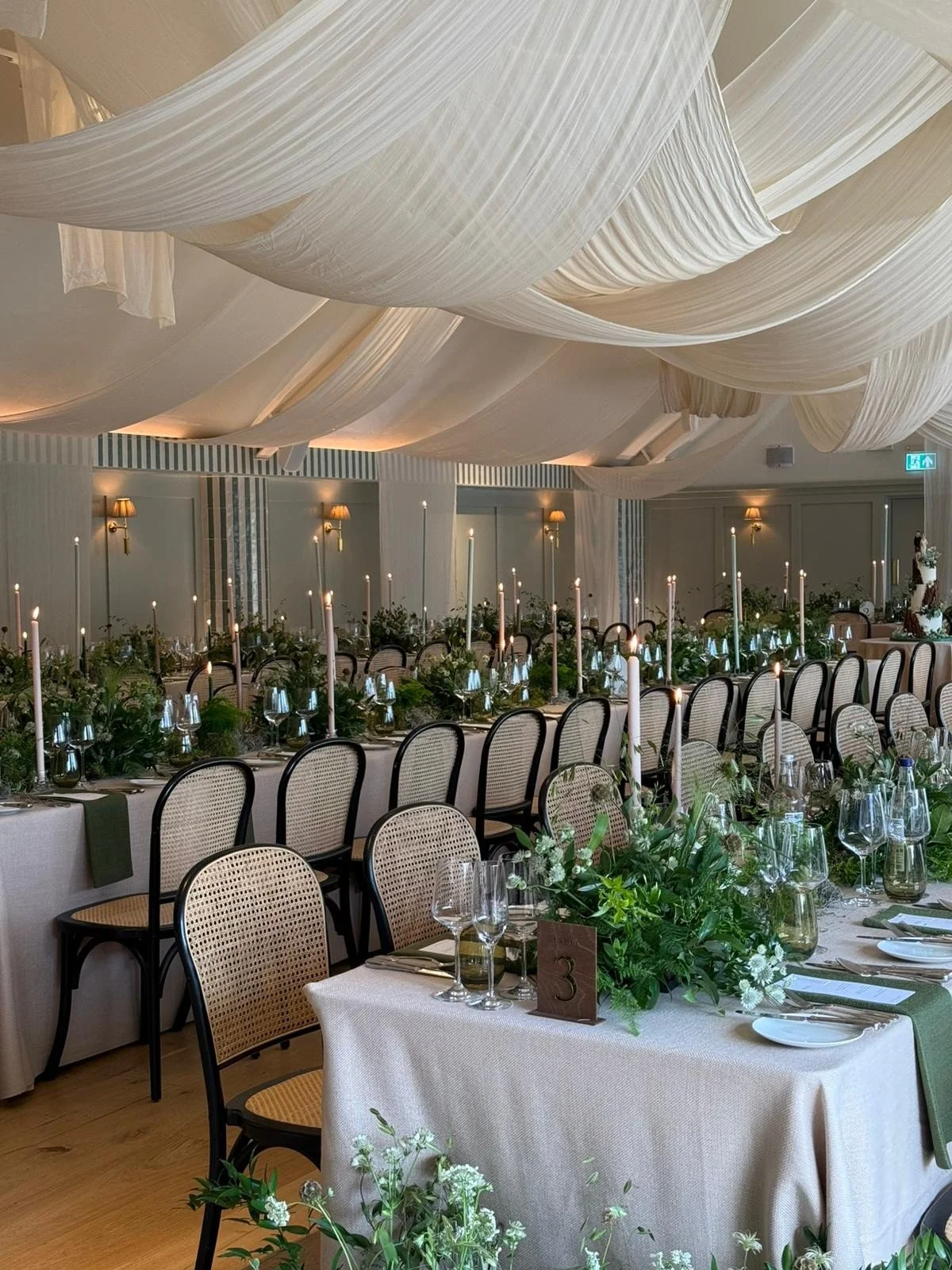 Kin House Kilvert Hall decorated with trestle tables with long dinner candles and all foliage table displays 