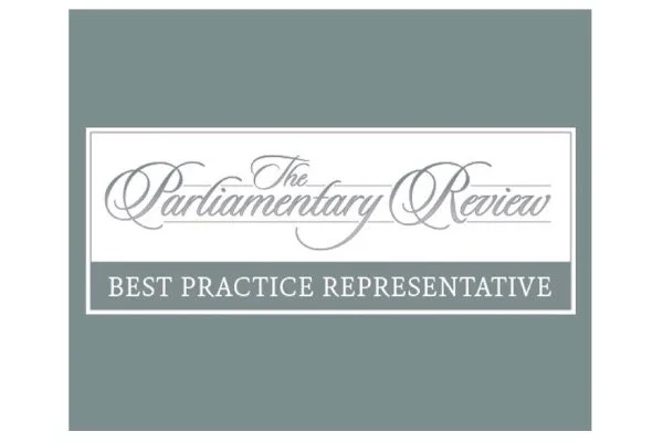 A certificate or award with the text 'The Parliament Review' and 'Best Practice Representative' on a teal background.