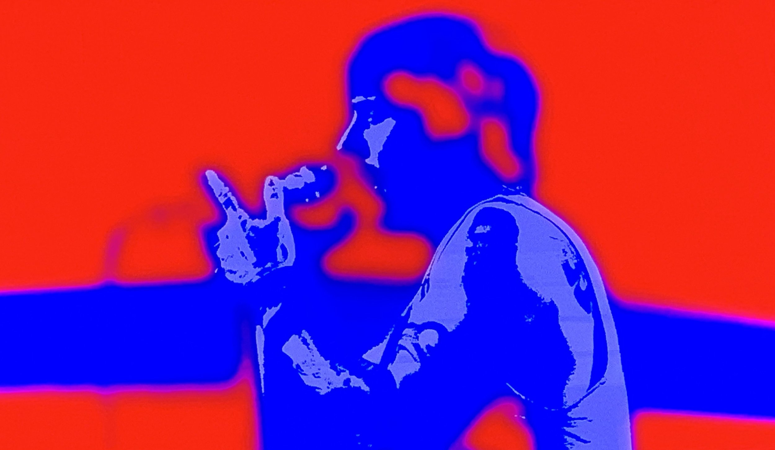 Silhouette of a person with superimposed red, blue, and purple colors, holding a finger near their lips as if making a shushing gesture.